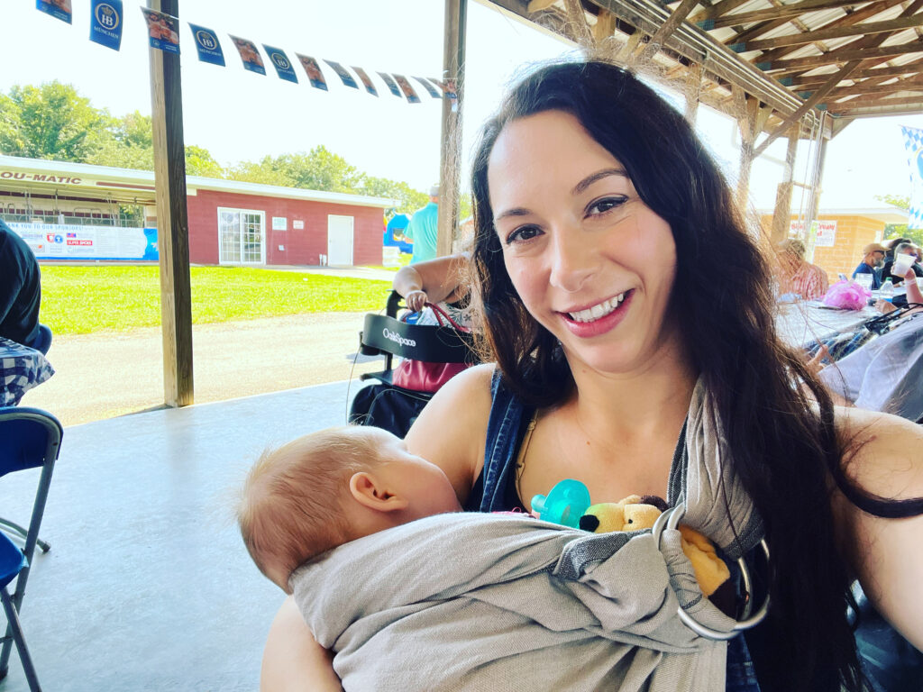 30s mom with new baby outside with grey ring sling