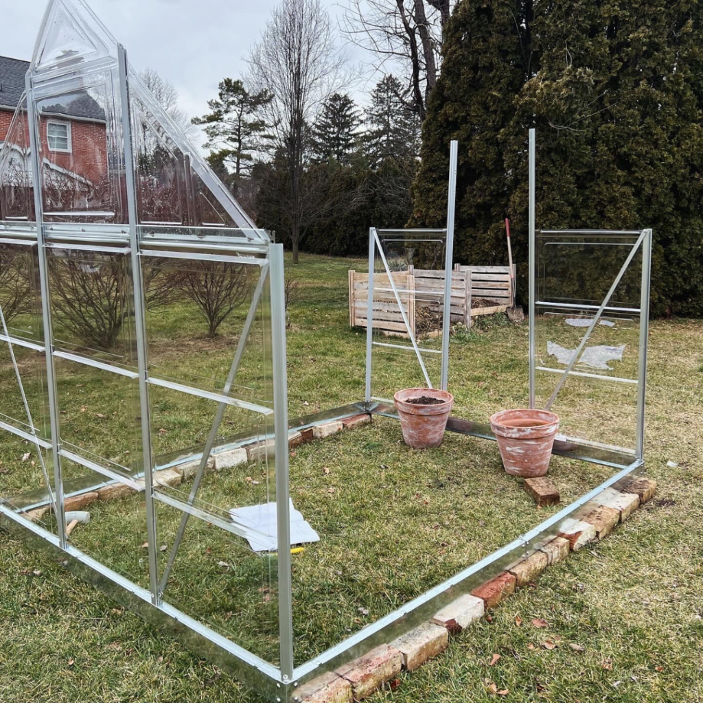 picture of metal and clear greenhouse under construction